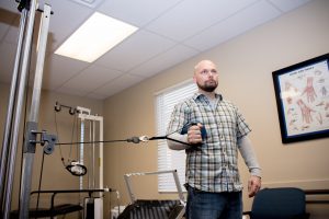 Patient doing hand and wrist therapy at the gym at brooks rehab