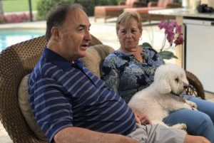 Bob Johnson and Sandy with their dog talking to someone off camera