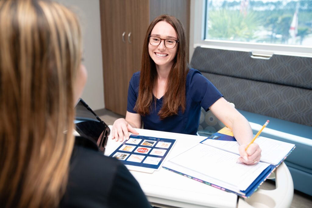 Motor speech therapist working with patient