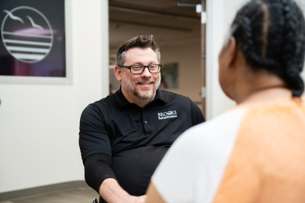 Workers Compensation staff member talking to a patient.