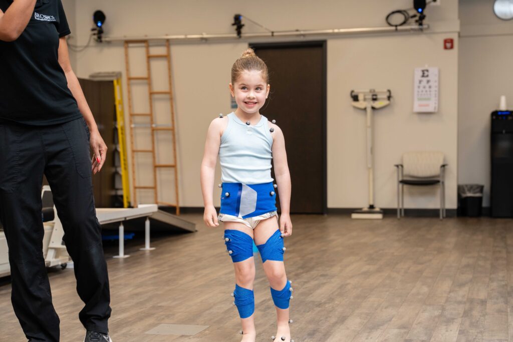 pediatric patient in motion analysis gear waiting for an assessment.
