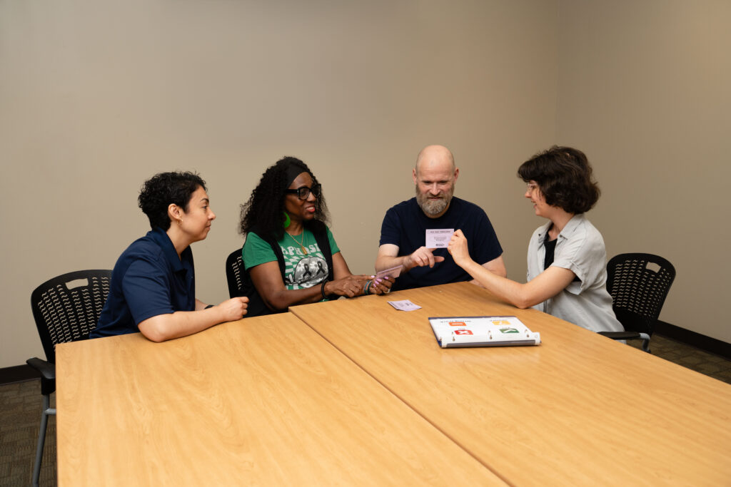 people at table looking at flash cards