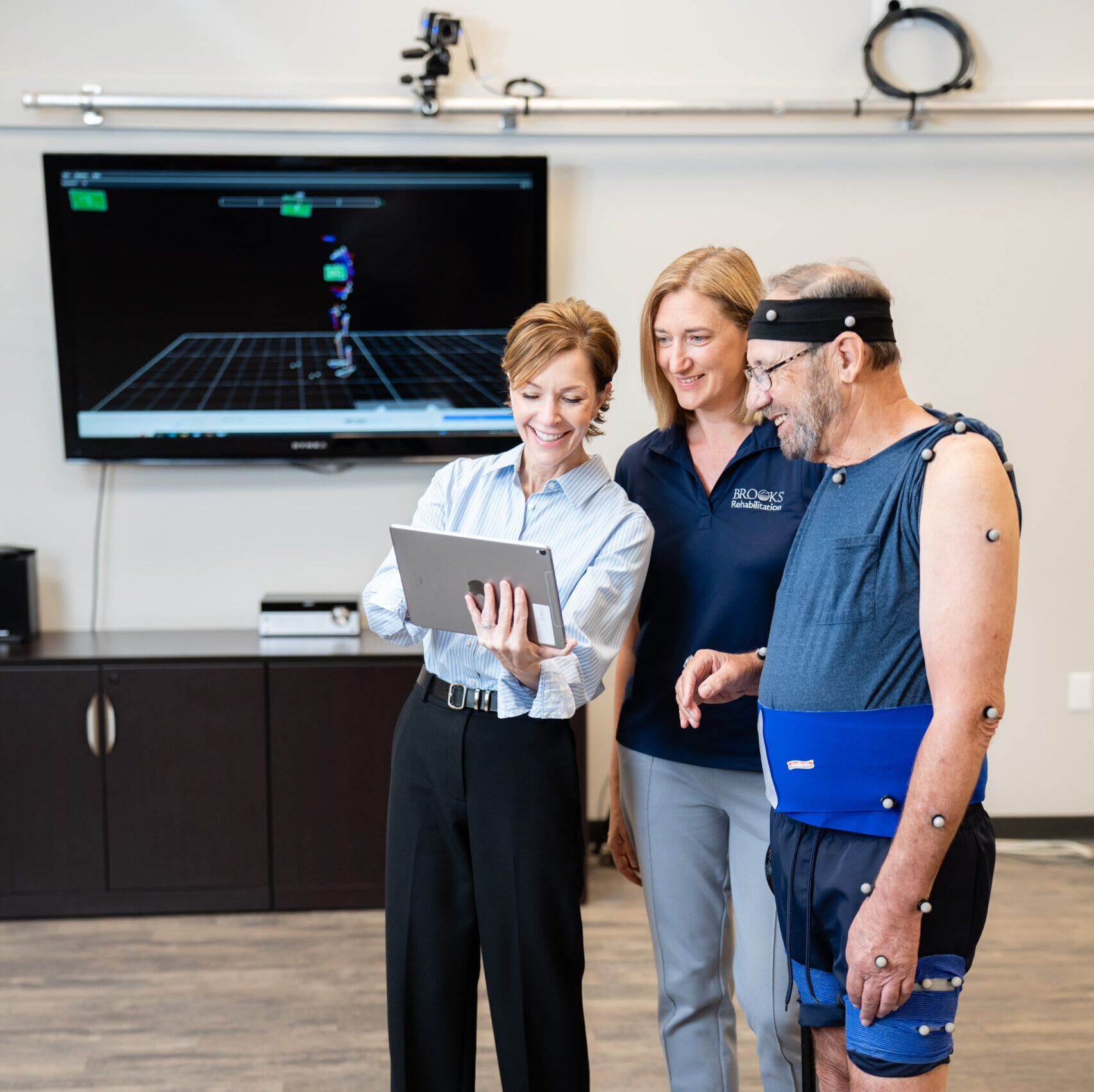 A researcher and clinician review a patients motion analysis with them.