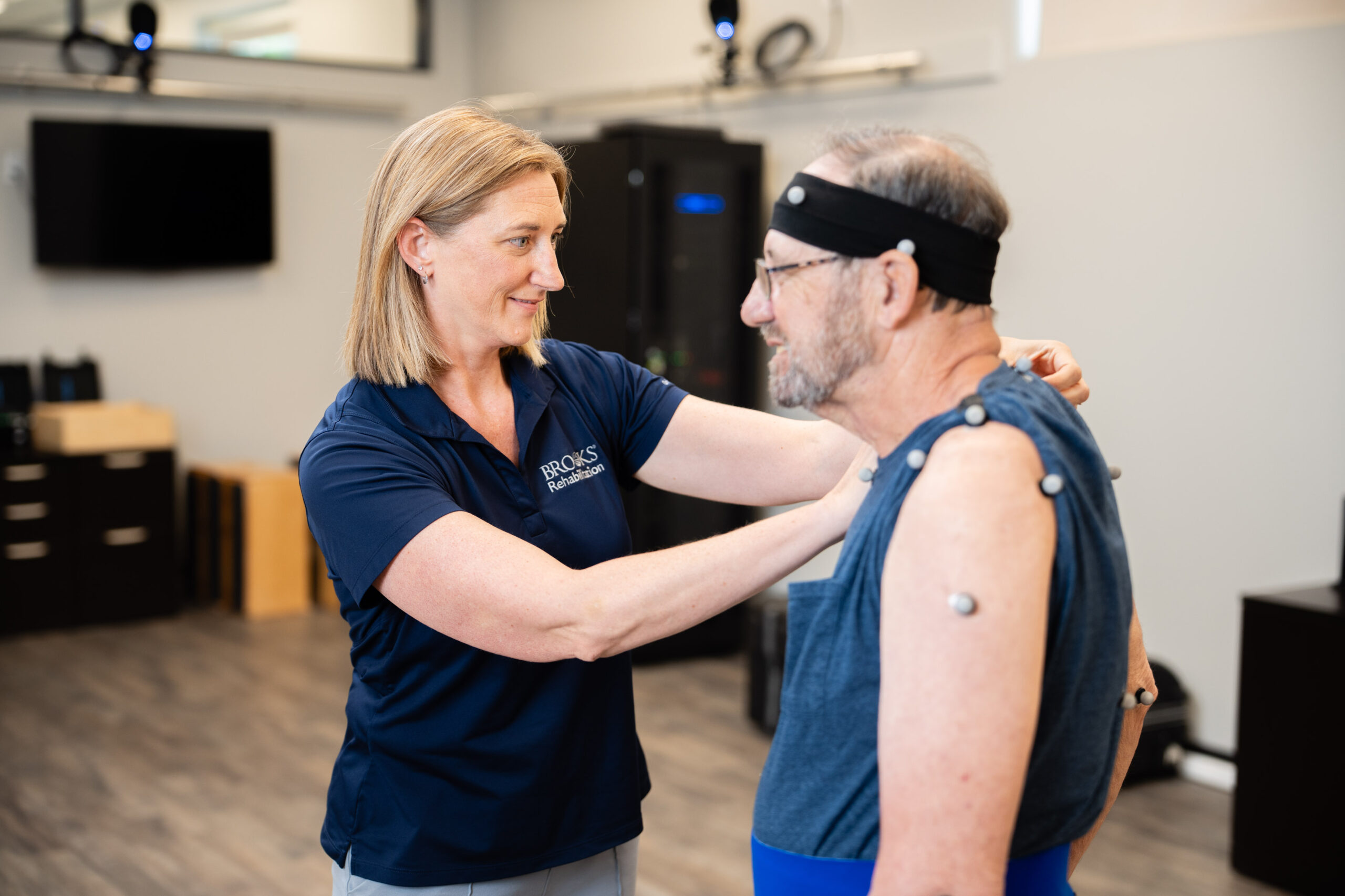 A clinician at the motion analysis center gets a patient ready to be screened.