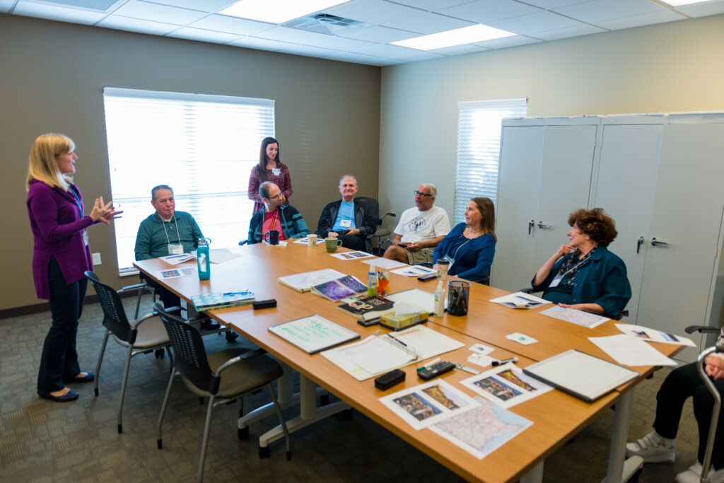 Group talking around table at the Aphasia Center