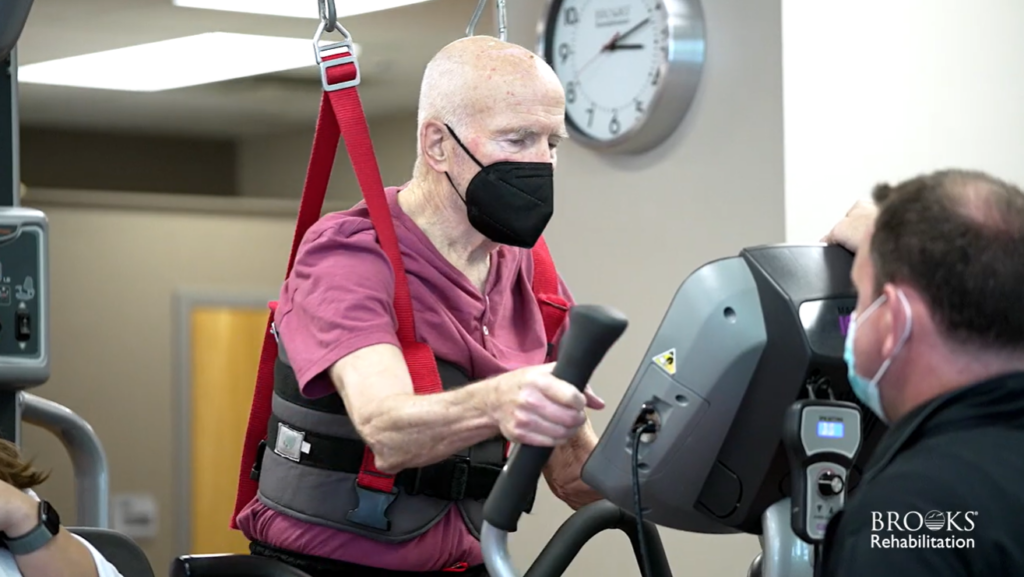 Man with mask on exercise machine