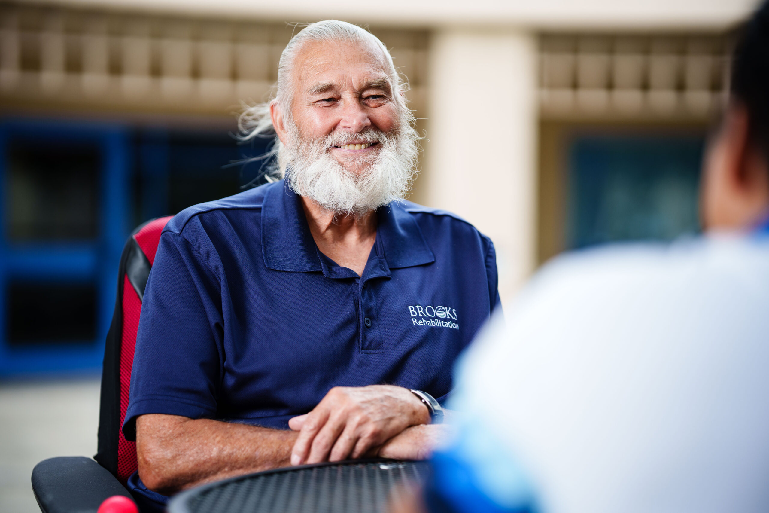 A peer mentor at Brooks listens to a newly disabled person.