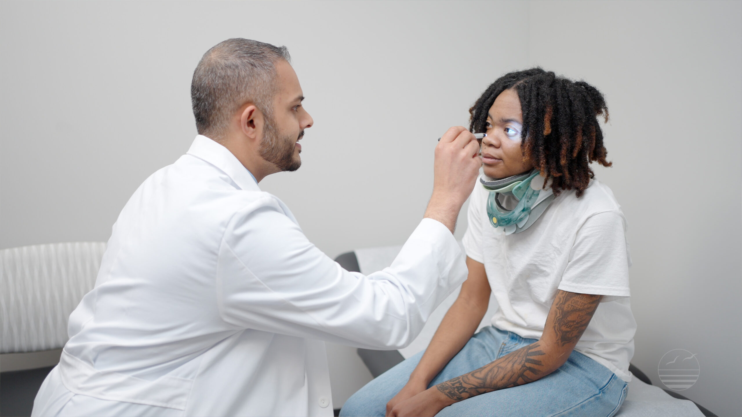Persaud examining a brain injury patient