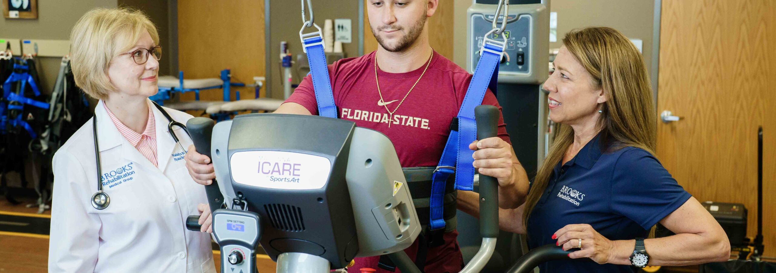 Patient gripping handlebars of iCARE while looking at the screen