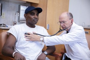 Doctor Trevor Paris Medical director at brooks rehab examining a patient