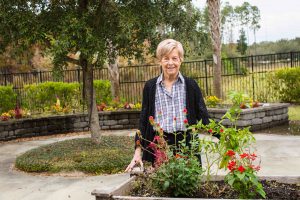 Woman with dementia poses with flowers