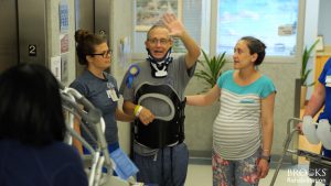 Johnnie Anderson waves to supporters at Brooks Rehabilitation