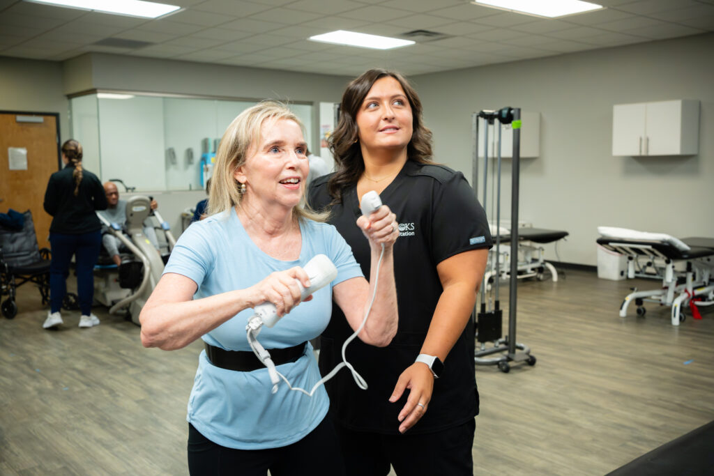 Brain Tumor patient practices motor skills using AR technology with therapist oversight.