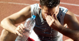 Man drenched with water bottle in hand