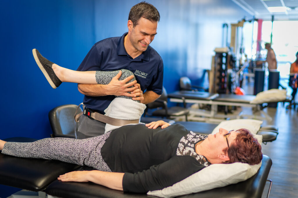 Physical Therapist Manual San Pablo works with his patient at Brooks Rehab in Nassau County