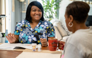 Home health care worker consults with a patient