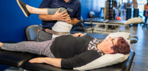 Therapist stretching a woman's leg