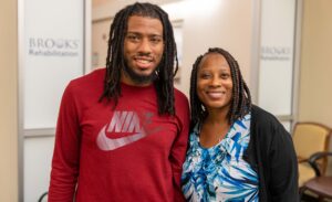 Tyler Woodard with his mother Juliette in front of Brooks' doors