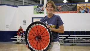 Ann Popik holding a bicycle wheel