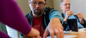 Aphasia patient pointing to something on a piece of paper