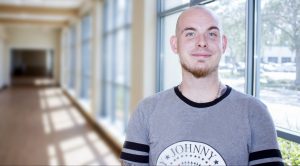 Headshot of man in a hallway