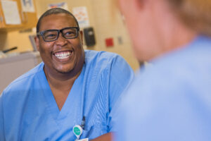 Two Hospital Inpatient staff members talking and smiling