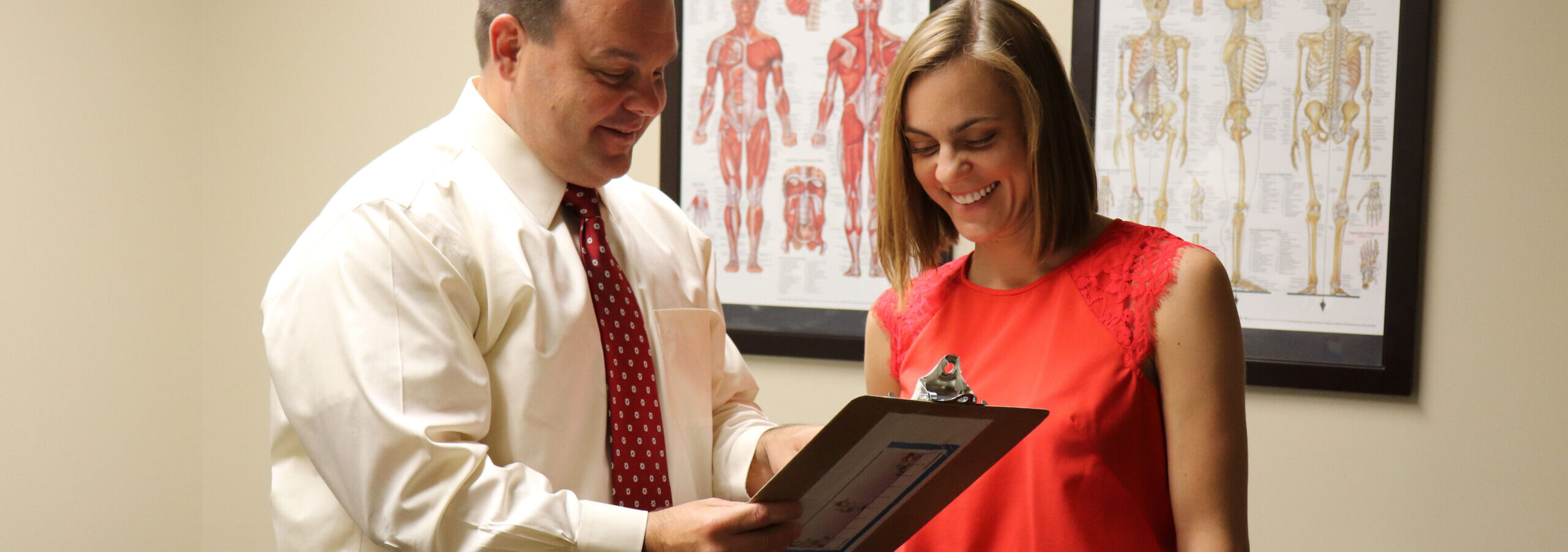 Doctor and staff member looking at a clipboard