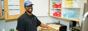 Antonio McCoy in a Brooks hat smiling at the camera