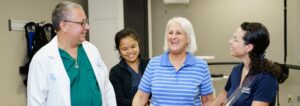 Patient listening to Brooks staff play guitar with two other staff members