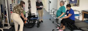 Deborah Stolley and two staff working with exercise bands