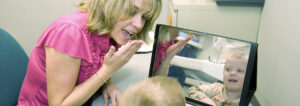 Toddler learning sign language in speech therapy