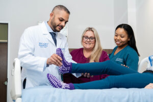 Persaud examining a brain injury patient