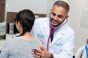 Persaud examining a brain injury patient