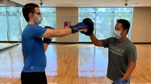 Two men boxing in a gym