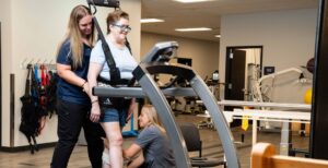 SCI patient walking on treadmill for PT