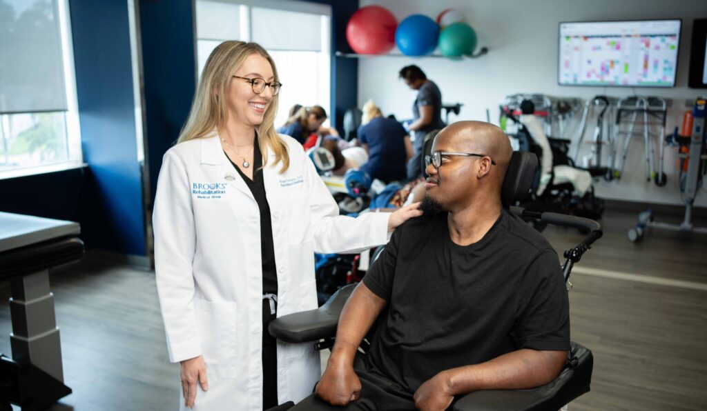 Dr Tribuzio smiling with SCI patient