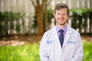 Dr. Brian Higdon smiling at the camera outside