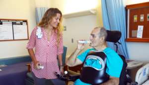 Man taking a breath test with the assistance of a Brooks staff member