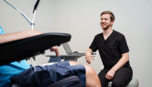 Dr. Brian Higdon near his laptop during a patient consultation