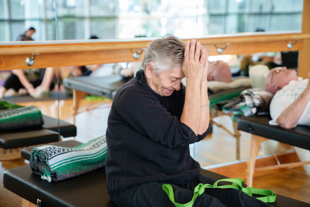 senior adult participating in adaptive yoga.