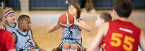 Kids in wheelchairs playing basketball