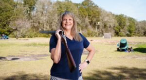 Meredyth Sauter posing with rifle