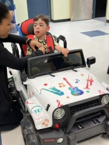Child receives a toy car to help with mobility. 