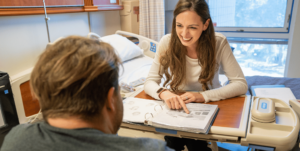 sppech therapist works with a stroke patient on communication.