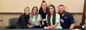 Madison Schemitz share a message of hope surrounded by Brooks Rehabilitation Therapists.