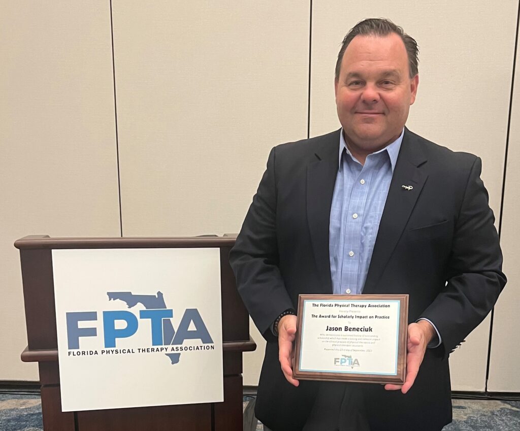 Brooks Research Jason Beneciuk recieves an award from FPTA.