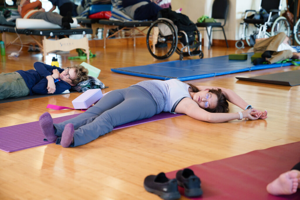 A person with disabilities attending a yoga class with brooks adaptive sports and recreation.