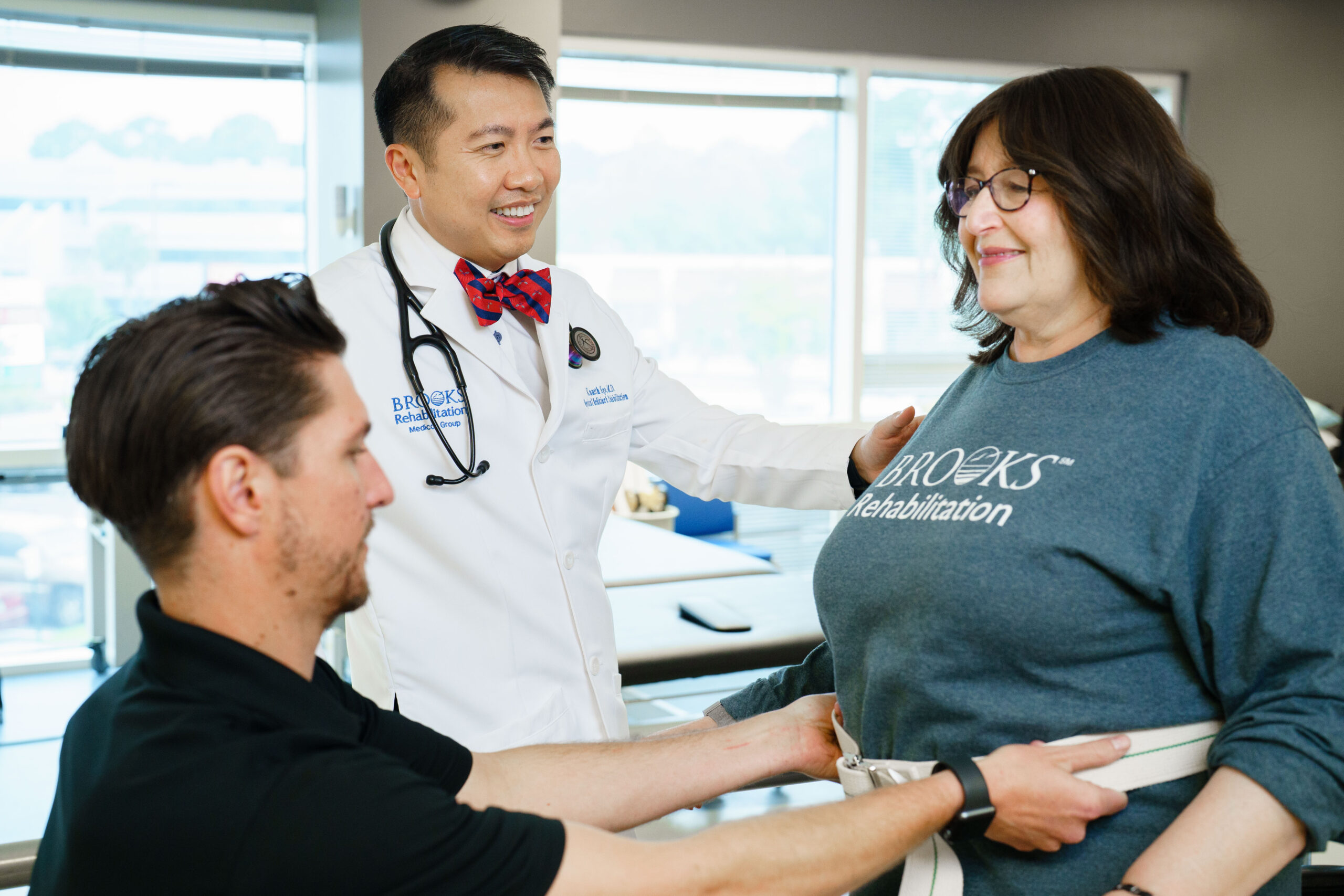 Dr. Ngo at Brooks Rehabilitation hospital oversees a therapy session with a brain injury patient