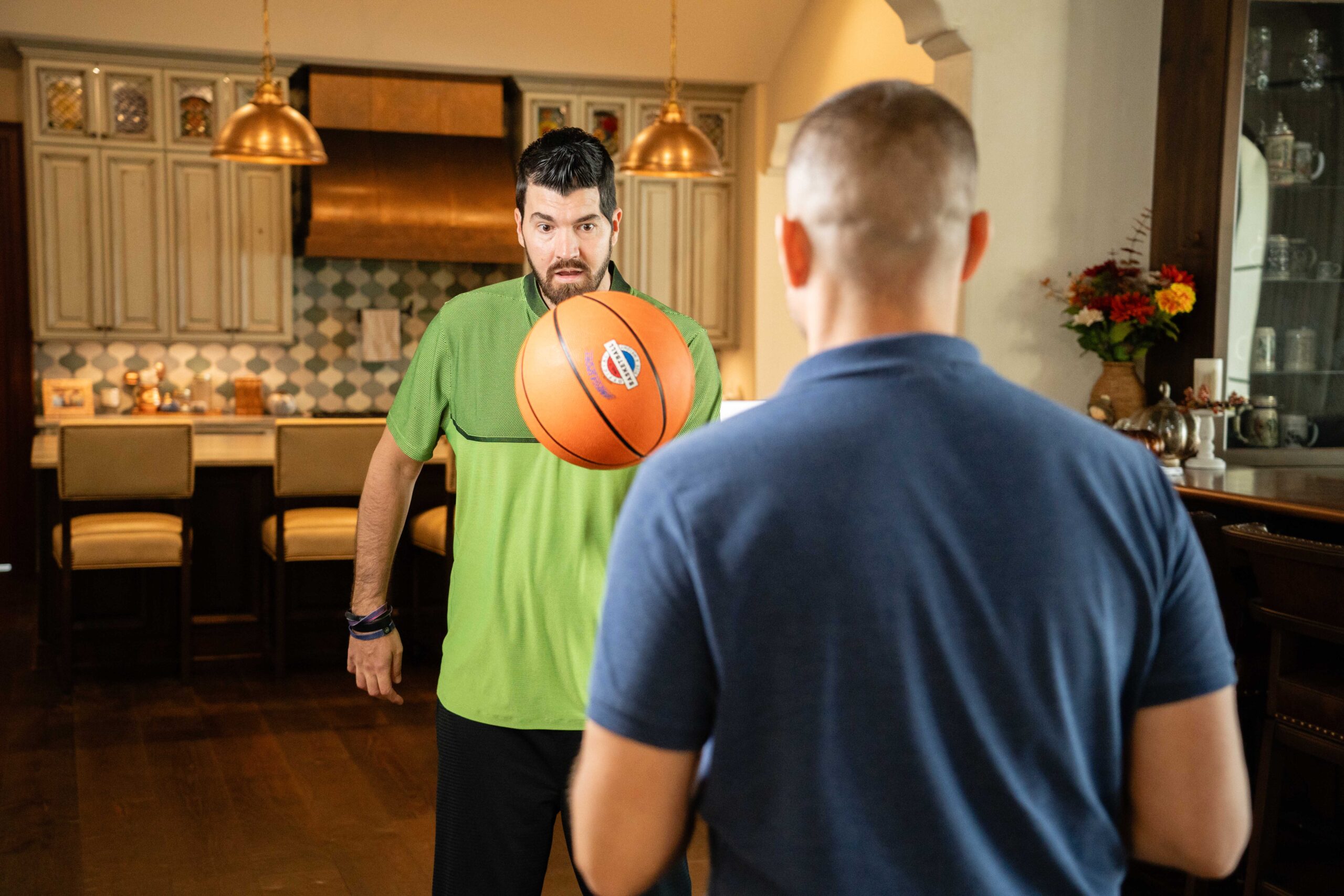 eric sorensen works on upper body coordination by tossing a basketball back and forth. 