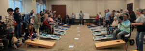 Amputees participate in Limb Loss day at Brooks Rehabilitation by playing cornhole.